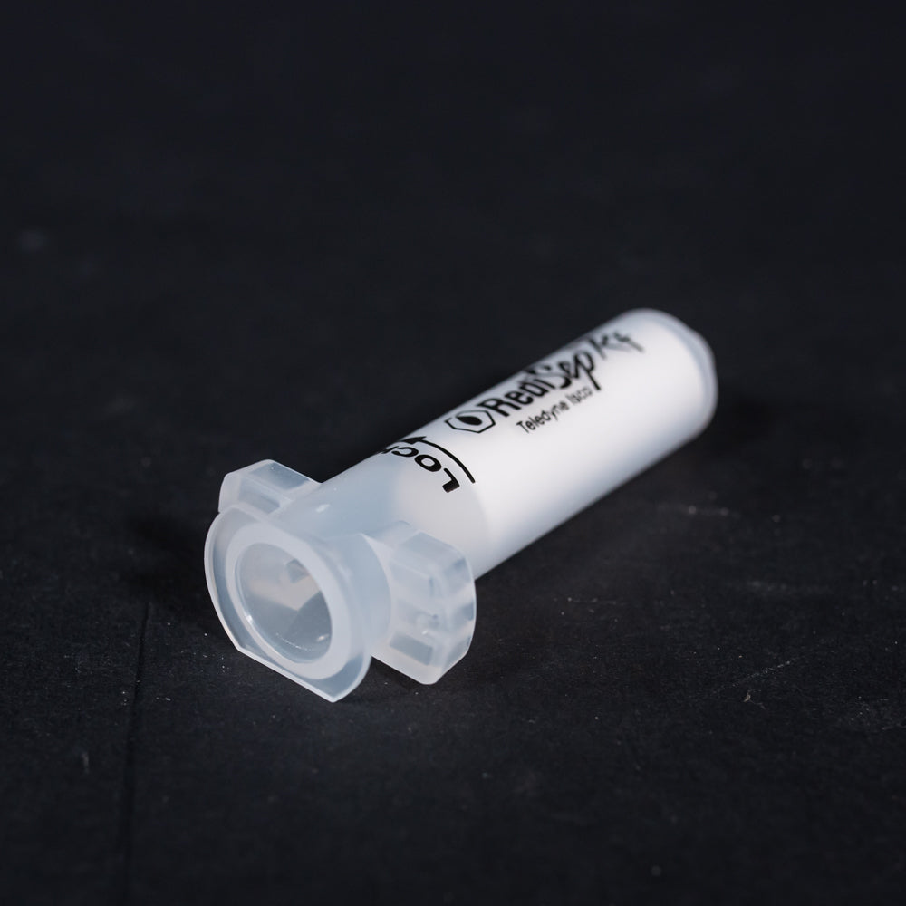 A small clear plastic cartridge displayed on a black background, creating a striking visual contrast between the two elements.