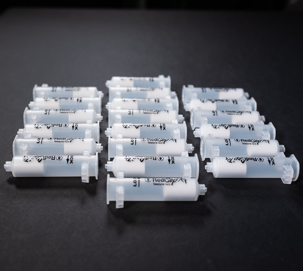 A set of small clear plastic cartridges displayed on a black background, creating a striking visual contrast between the two elements.