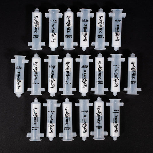 A set of small clear plastic cartridges displayed on a black background, creating a striking visual contrast between the two elements.