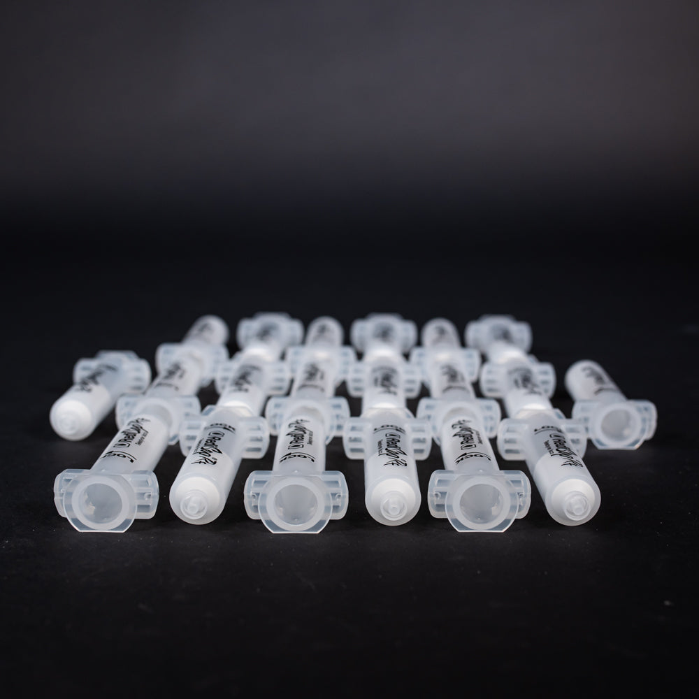 A set of small clear plastic cartridges displayed on a black background, creating a striking visual contrast between the two elements.