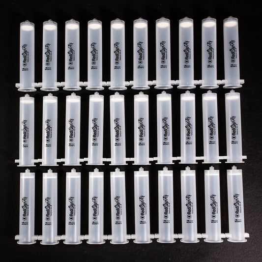 A set of small clear plastic cartridges displayed on a black background, creating a striking visual contrast between the two elements.