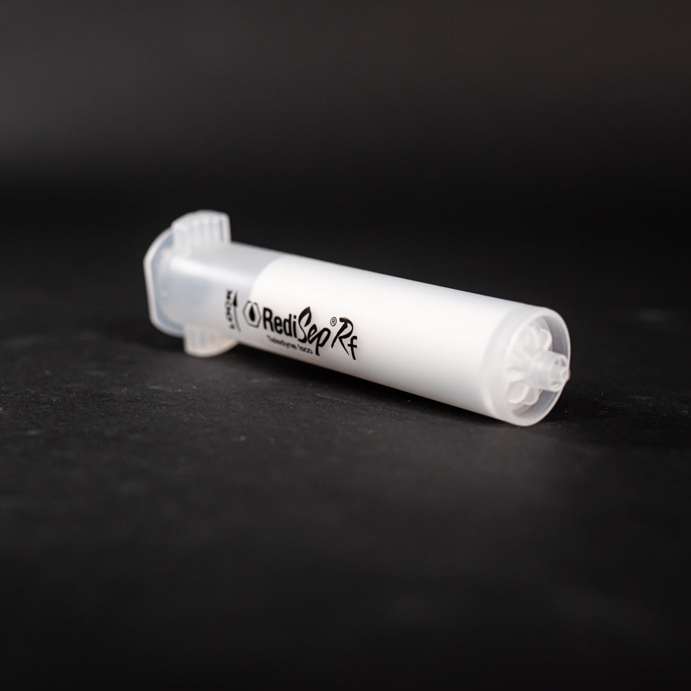 A small clear plastic cartridge displayed on a black background, creating a striking visual contrast between the two elements.