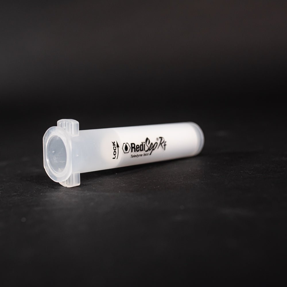 A small clear plastic cartridge displayed on a black background, creating a striking visual contrast between the two elements.