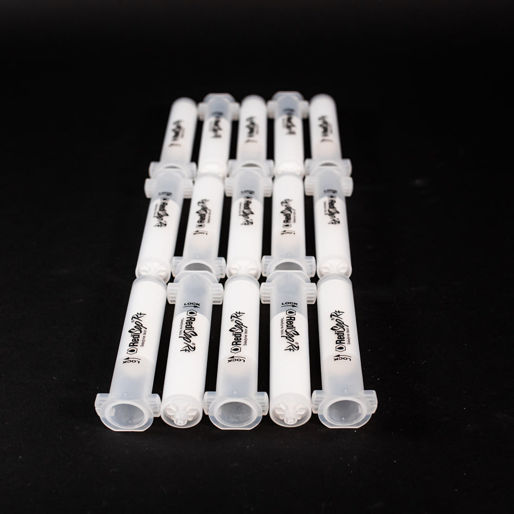 A set of small clear plastic cartridges displayed on a black background, creating a striking visual contrast between the two elements.