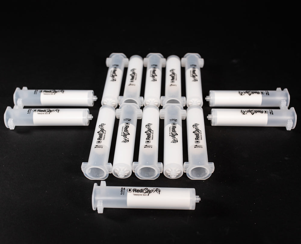 A set of small clear plastic cartridges displayed on a black background, creating a striking visual contrast between the two elements.