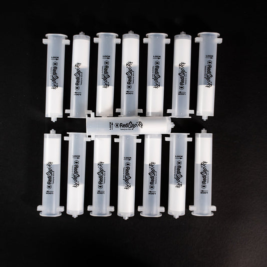 A set of small clear plastic cartridges displayed on a black background, creating a striking visual contrast between the two elements.
