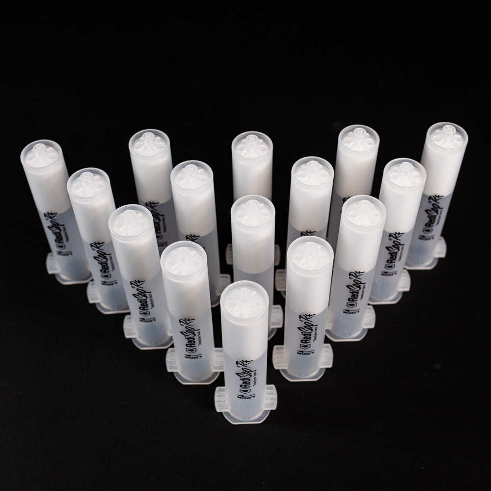 A set of small clear plastic cartridges displayed on a black background, creating a striking visual contrast between the two elements.