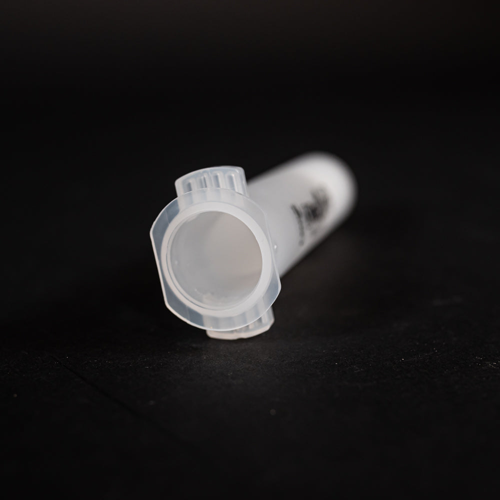 A small clear plastic cartridge displayed on a black background, creating a striking visual contrast between the two elements.